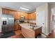 Kitchen with wood cabinets, stainless steel appliances, and an island with a sink at 661 Village Field Nw Ct, Suwanee, GA 30024