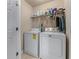 Functional laundry room featuring a washer, dryer, and convenient shelving at 661 Village Field Nw Ct, Suwanee, GA 30024
