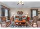 Living room featuring neutral walls, hardwood floors, area rug, sofa, two chairs and window at 661 Village Field Nw Ct, Suwanee, GA 30024