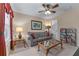 Comfortable living room with neutral decor, ceiling fan, and ample seating at 661 Village Field Nw Ct, Suwanee, GA 30024