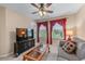 Cozy living room with media center, comfortable seating, and natural light at 661 Village Field Nw Ct, Suwanee, GA 30024