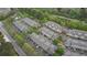 Overhead shot of complex showing roof lines, landscaping, parking, and surrounding woods at 3107 Woodland Ln, Alpharetta, GA 30009