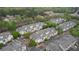 An aerial view showcases a townhome community with lush trees, swimming pool, and well-maintained landscaping at 3107 Woodland Ln, Alpharetta, GA 30009