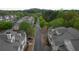 Community street view lined with townhomes, trees, and lush greenery creating a tranquil neighborhood setting at 3107 Woodland Ln, Alpharetta, GA 30009