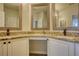 Bathroom featuring a vanity area with granite countertop and double mirrors for a modern look at 3107 Woodland Ln, Alpharetta, GA 30009