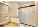 Bright bathroom with a granite vanity, large mirror, and tub with sliding glass doors at 3107 Woodland Ln, Alpharetta, GA 30009