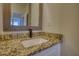 Bathroom featuring granite countertops, white cabinets, a modern faucet, and framed mirror at 3107 Woodland Ln, Alpharetta, GA 30009