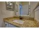 Bathroom vanity with granite countertop and bronze fixtures at 3107 Woodland Ln, Alpharetta, GA 30009