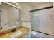 Bathroom featuring granite vanity, large mirror, and shower with sliding glass door at 3107 Woodland Ln, Alpharetta, GA 30009
