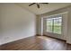 Bedroom with hardwood flooring, a ceiling fan, and a large window at 3107 Woodland Ln, Alpharetta, GA 30009
