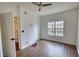 Well-lit bedroom with hardwood floors, a ceiling fan, and a window overlooking the neighborhood at 3107 Woodland Ln, Alpharetta, GA 30009