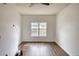 This bright bedroom features dark hardwood floors, neutral walls, and a ceiling fan at 3107 Woodland Ln, Alpharetta, GA 30009