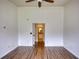 An empty bedroom featuring wood-look flooring, white walls, and a ceiling fan at 3107 Woodland Ln, Alpharetta, GA 30009