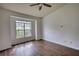 Bedroom with hardwood flooring, a ceiling fan, and a large window at 3107 Woodland Ln, Alpharetta, GA 30009