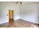This spacious bedroom features a ceiling fan and hardwood floors, with doorway to another room at 3107 Woodland Ln, Alpharetta, GA 30009