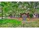 Welcoming entrance to The Woodlands at Webb Bridge community, featuring brick signage and colorful flowerbeds at 3107 Woodland Ln, Alpharetta, GA 30009