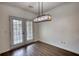 Dining area featuring hardwood floors and modern lighting with French doors to the exterior at 3107 Woodland Ln, Alpharetta, GA 30009