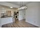 Dining area with stylish light fixture, hardwood floors and a breakfast bar at 3107 Woodland Ln, Alpharetta, GA 30009