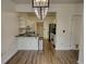 Open-concept layout connects dining area and kitchen, complete with elegant light fixtures at 3107 Woodland Ln, Alpharetta, GA 30009