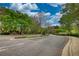 Scenic view of Woodland's welcoming entrance with lush greenery and street sign at 3107 Woodland Ln, Alpharetta, GA 30009