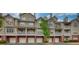 Attractive condo exterior showcasing brick accents and multiple stories with individual garages at 3107 Woodland Ln, Alpharetta, GA 30009