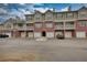 Multi-level condo/townhome building with individual garages and brick and siding exterior at 3107 Woodland Ln, Alpharetta, GA 30009
