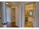 Hallway leading to a bathroom with stylish granite countertop and double mirrors at 3107 Woodland Ln, Alpharetta, GA 30009