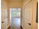Hallway showcasing hardwood floors and access to the main living area with natural light at 3107 Woodland Ln, Alpharetta, GA 30009