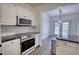 Well-appointed kitchen with stainless steel appliances and an open view to the dining area at 3107 Woodland Ln, Alpharetta, GA 30009