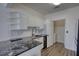 Bright kitchen features granite countertops, stainless appliances, and a convenient in-unit laundry room at 3107 Woodland Ln, Alpharetta, GA 30009