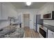 Full kitchen with stainless appliances next to laundry room and eat-in kitchen area at 3107 Woodland Ln, Alpharetta, GA 30009