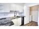 Bright kitchen features granite countertops, stainless appliances, and a convenient in-unit laundry room at 3107 Woodland Ln, Alpharetta, GA 30009