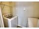 Bright laundry room features a washing machine, dryer, and wire rack shelving at 3107 Woodland Ln, Alpharetta, GA 30009