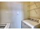 Bright laundry room with a washing machine, dryer, and wire rack shelving at 3107 Woodland Ln, Alpharetta, GA 30009
