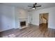Inviting living room featuring a fireplace, hardwood floors, ceiling fan and neutral paint at 3107 Woodland Ln, Alpharetta, GA 30009