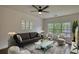 Comfortable living room featuring a ceiling fan, plush seating, and a large window at 3107 Woodland Ln, Alpharetta, GA 30009