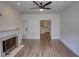 Spacious living room featuring a fireplace, hardwood floors, and multiple entryways at 3107 Woodland Ln, Alpharetta, GA 30009