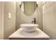 Stylish powder room with vessel sink, modern faucet, and elegant mirror at 3107 Woodland Ln, Alpharetta, GA 30009