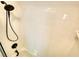 Shower with dark bronze fixtures and white tiled walls at 3107 Woodland Ln, Alpharetta, GA 30009
