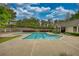 A community pool featuring crystal-clear water, a pool house, and lush landscaping at 3107 Woodland Ln, Alpharetta, GA 30009
