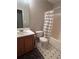 Standard bathroom with a sink and vanity, toilet, and a shower with a white and grey striped curtain at 3236 Grove Nw Trl, Acworth, GA 30101