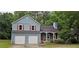 Charming two-story home with a two-car garage, red shutters, and mature trees in the front yard at 3236 Grove Nw Trl, Acworth, GA 30101
