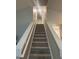 Hallway featuring a carpeted staircase with white painted banisters, leading to the upper level of the home at 3236 Grove Nw Trl, Acworth, GA 30101