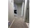 Hallway with neutral-toned walls and carpet, showcasing doorways to other rooms in the house at 3236 Grove Nw Trl, Acworth, GA 30101