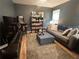Living room boasting an arcade game, TV, sofa, and shelving with games, perfect for entertainment at 3236 Grove Nw Trl, Acworth, GA 30101