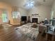 Cozy living room featuring hardwood floors, a fireplace, and an open layout leading to the kitchen at 3236 Grove Nw Trl, Acworth, GA 30101