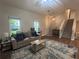 Inviting living room with hardwood floors, a comfortable sofa, and staircase access at 3236 Grove Nw Trl, Acworth, GA 30101