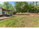 Exterior view of a backyard featuring a covered patio and a spacious lawn at 3607 Anna Nw Ln, Kennesaw, GA 30144