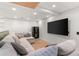 Basement featuring an oversized sectional, large TV, and entertainment area with modern flooring at 3607 Anna Nw Ln, Kennesaw, GA 30144