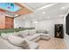 Basement featuring an oversized sectional, large TV, and entertainment area with modern flooring at 3607 Anna Nw Ln, Kennesaw, GA 30144